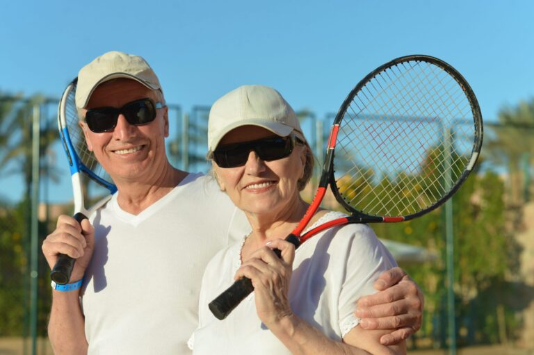 Senior couple playing tennis tennis courts