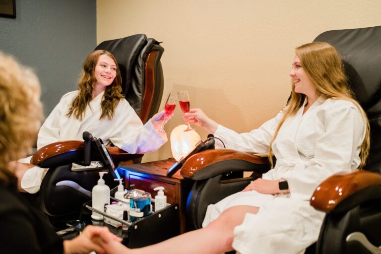 Two young women toasting a mimosa while enjoying spa pedicure|Spa Promotion Facial Two young women toasting a mimosa while enjoying spa pedicure|Spa Promotion Facial
