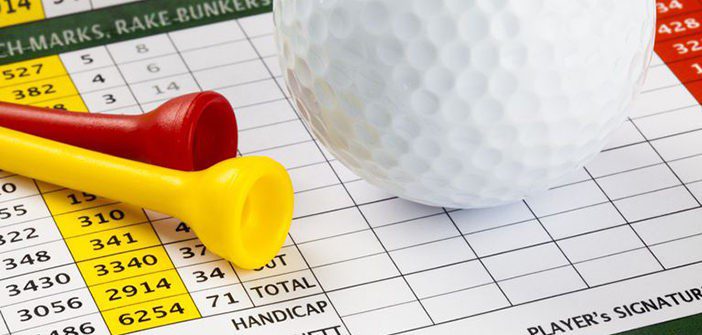 golf scorecard A white golf ball and yellow and red tees lay on top of a golf scorecard.